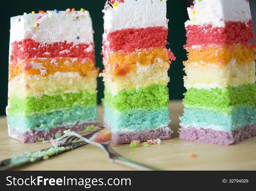 Close up three pieces of rainbow cake. Close up three pieces of rainbow cake