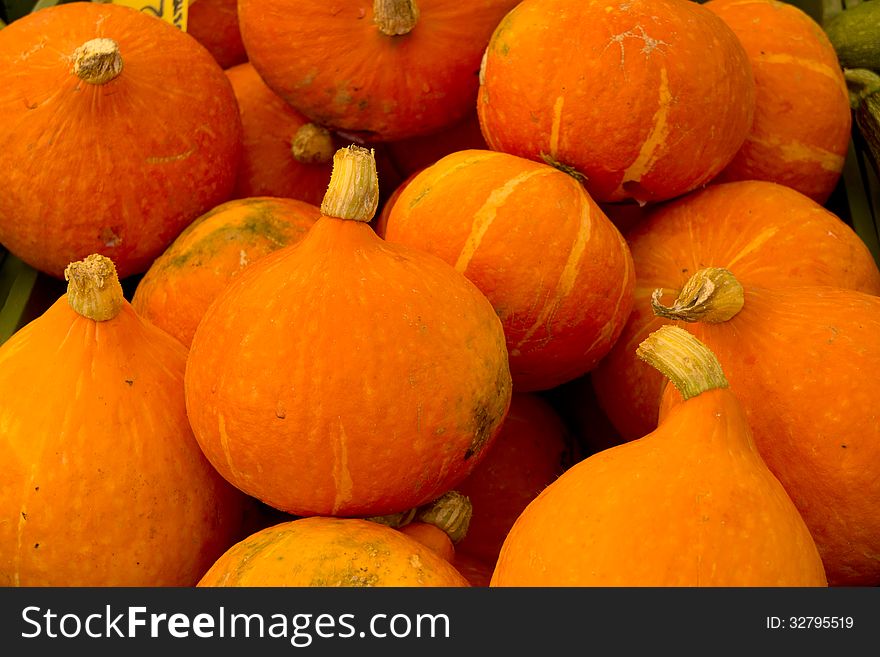 Round orange pumpkins on a market stall