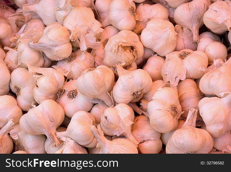 A background of pink garlic heads