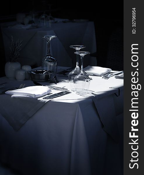 Stylish restaurant table with glasses and cutlery waiting for guests. Stylish restaurant table with glasses and cutlery waiting for guests