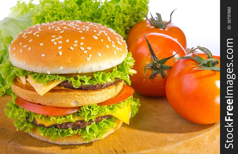 Big hamburger with vegetable background