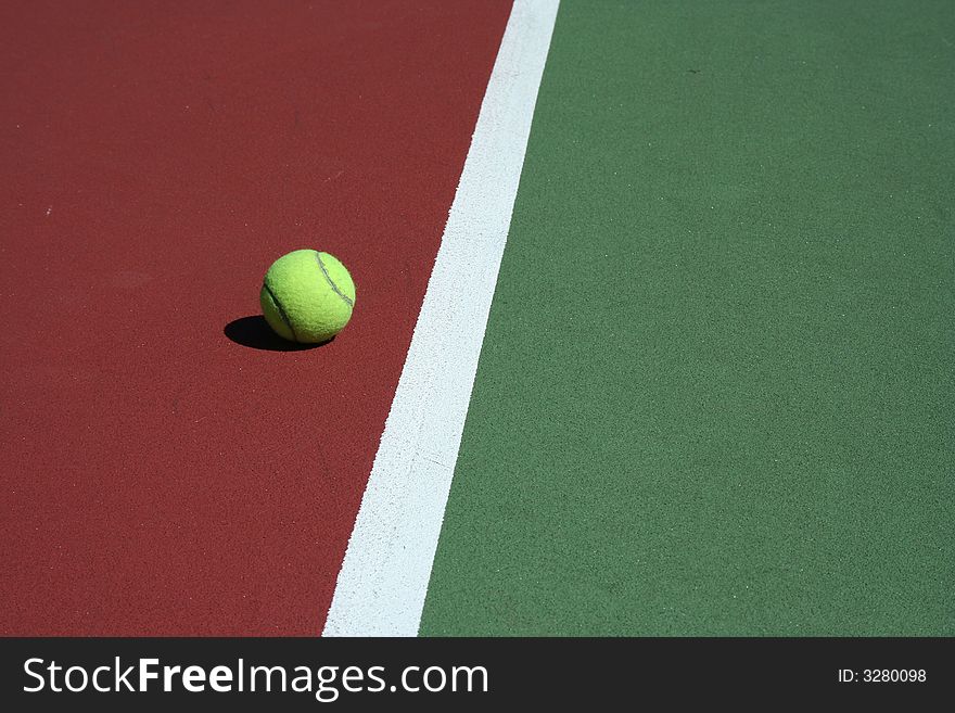 A Tennis Ball out of bounds with white line