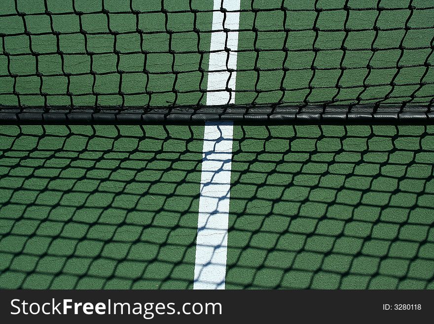 A Tennis net and shadows with white line