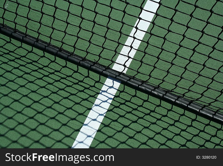 A Tennis net and shadows with white line