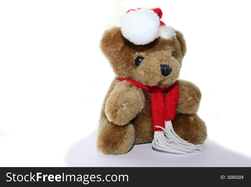 Teddy bear in christmas red cap and red scarf. Teddy bear in christmas red cap and red scarf