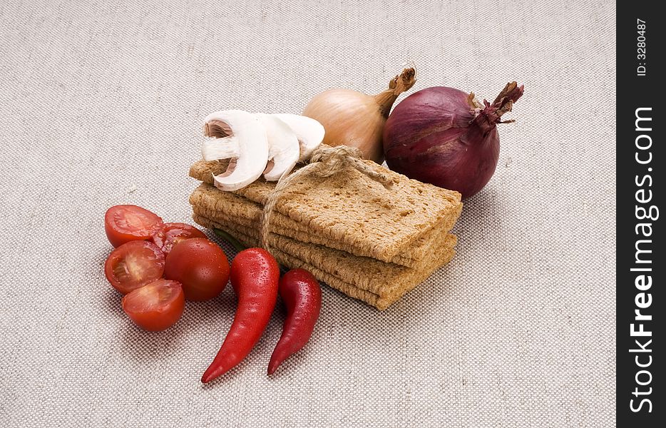 Food components composition containing diet bread, red and white onion red peppers, cherry tomatoes and sliced mushrooms
