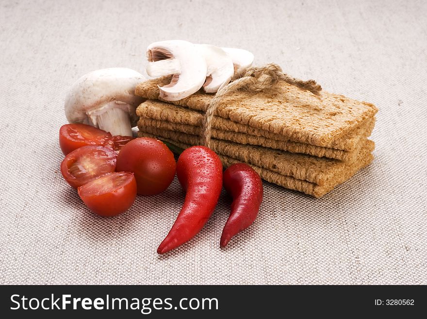 Food components composition containing diet bread, red and white onion red peppers, cherry tomatoes and sliced mushrooms