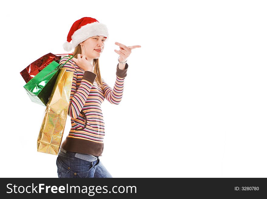 Young  christmas girl in red hat with package show finger. Young  christmas girl in red hat with package show finger