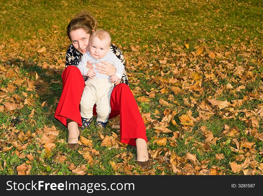 Little child embraces mother and looks out at her shoulder. Little child embraces mother and looks out at her shoulder