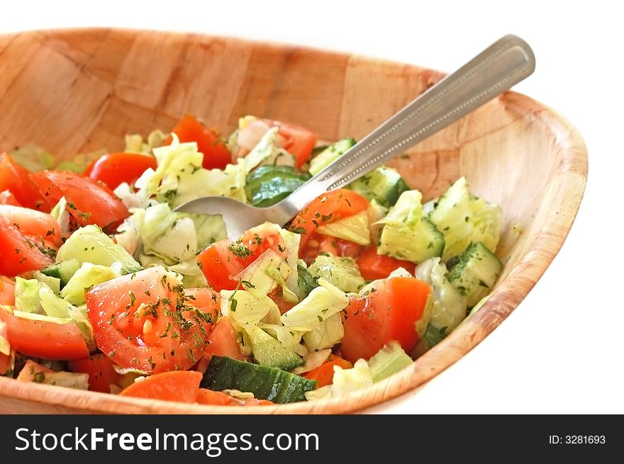 Fresh Healthy salad consisting of cucumber,tomato and iceberg lettuce served in a wooden bowl