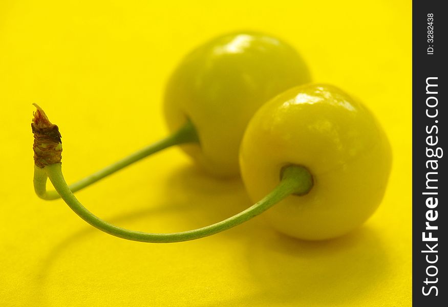Yellow cherry on a yellow background