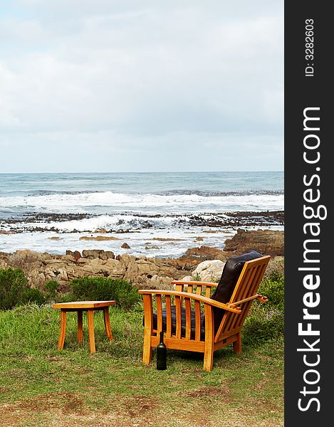 Wooden chair standing outside by the ocean. Perfect leisure scene