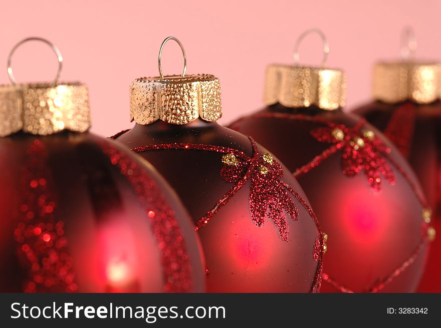 Red christmas decoration balls against pink background