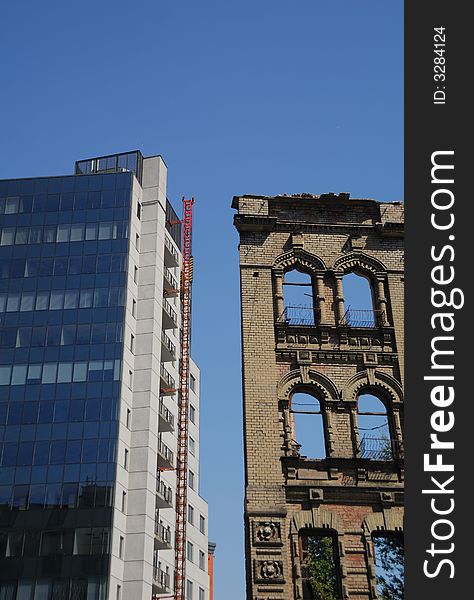 Modern business building and ruin of old building. Modern business building and ruin of old building