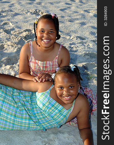 Two african american sisters posing outside on a beach. Two african american sisters posing outside on a beach