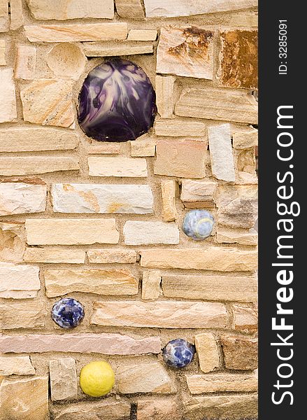 A stone wall with balls embedded useful for a background. A stone wall with balls embedded useful for a background
