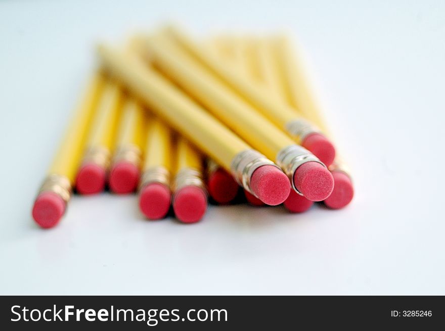 A group of new yellow number  nine pencils, shallow depth of field, white background.  A group of new yellow number  nine pencils, shallow depth of field, white background