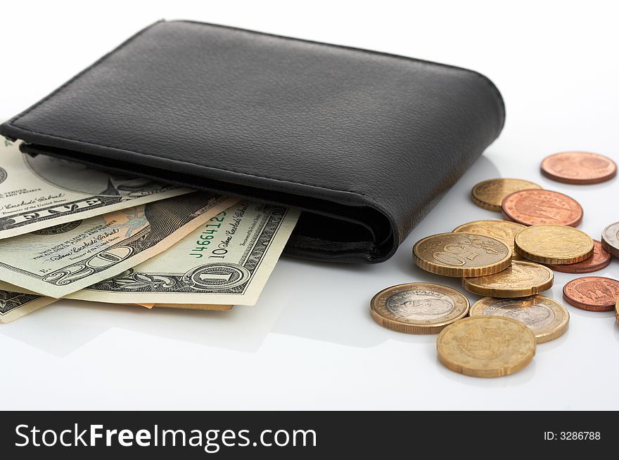 A few dollar bills inside a leather wallet. A few dollar bills inside a leather wallet