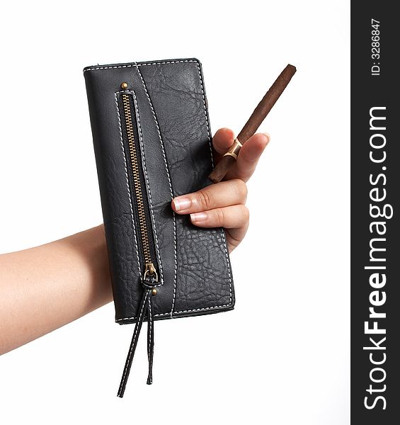 A hand holding a cigar and a black leather purse