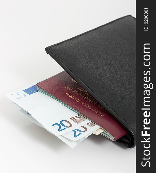 A passport and a wallet with euro bills. A passport and a wallet with euro bills