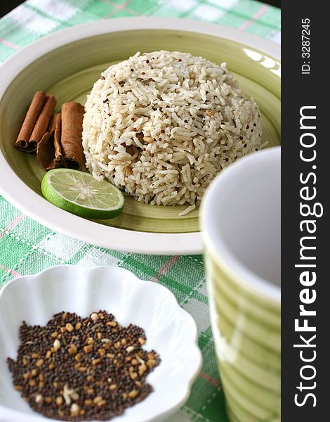 Asian exotic spiced rice served in a green earthenware plate set. Asian exotic spiced rice served in a green earthenware plate set