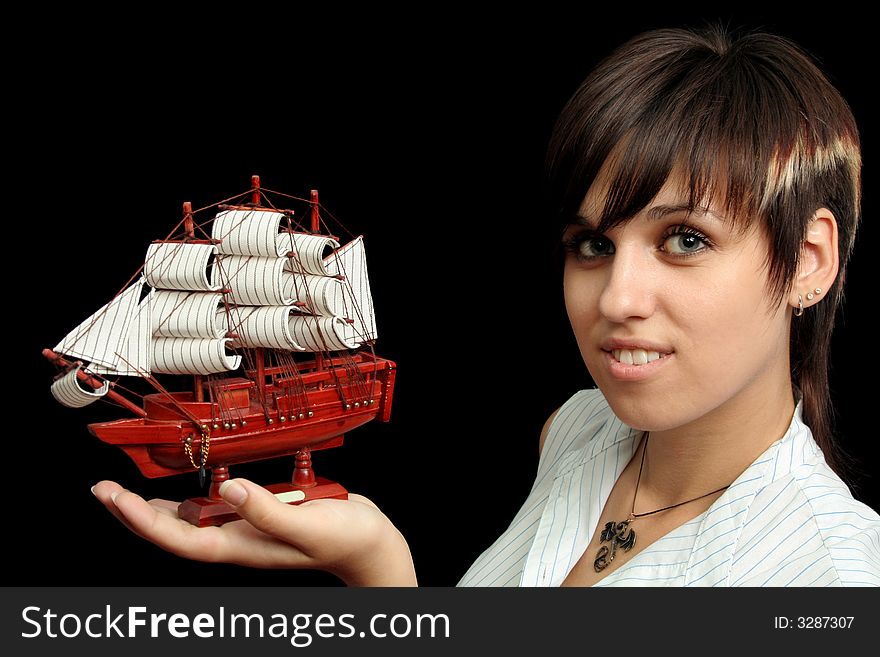 Smiling girl with the toy ship