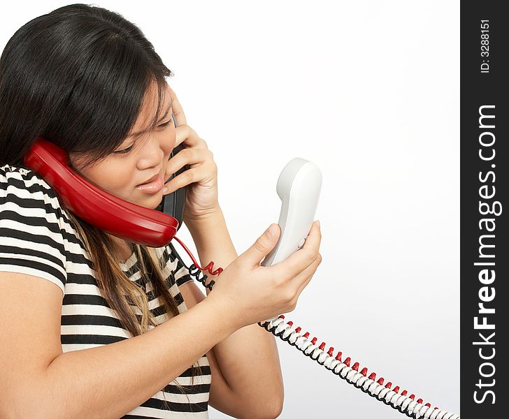 A woman answering multiple phones over a white background. A woman answering multiple phones over a white background