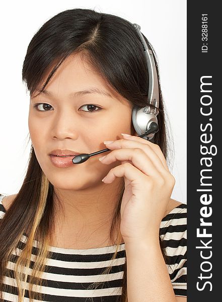 A woman with a headset on over a white background. A woman with a headset on over a white background