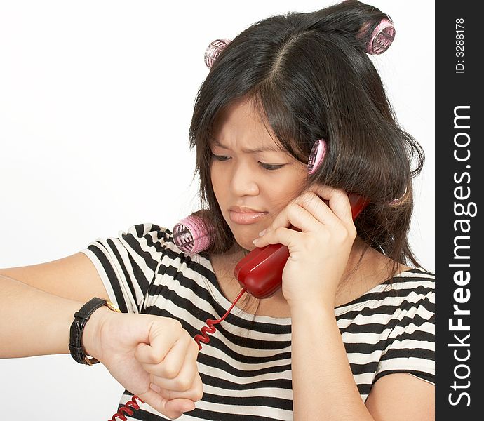 A woman with hair rollers making a phone call. A woman with hair rollers making a phone call