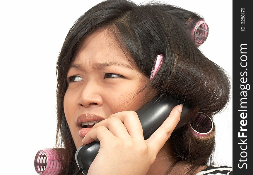 A woman with hair rollers making a phone call. A woman with hair rollers making a phone call