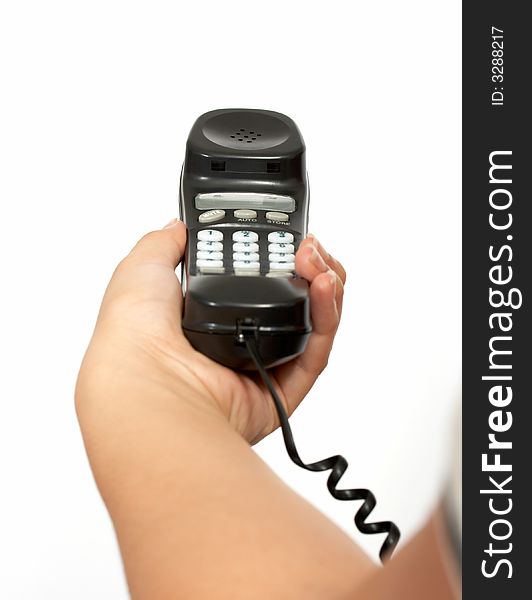 A hand holding a  telephone handset over a white background. A hand holding a  telephone handset over a white background