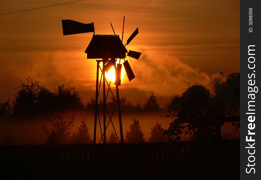 Windmill in sun in field. Windmill in sun in field