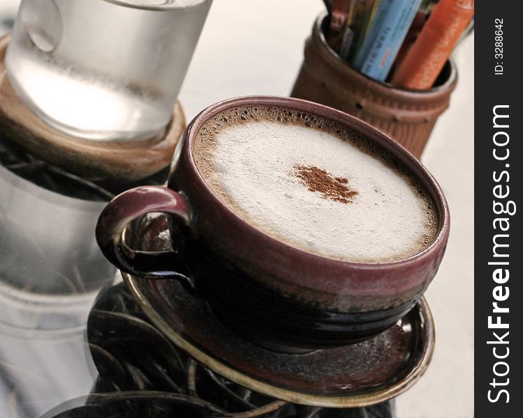 Cappuccino and a glass of water