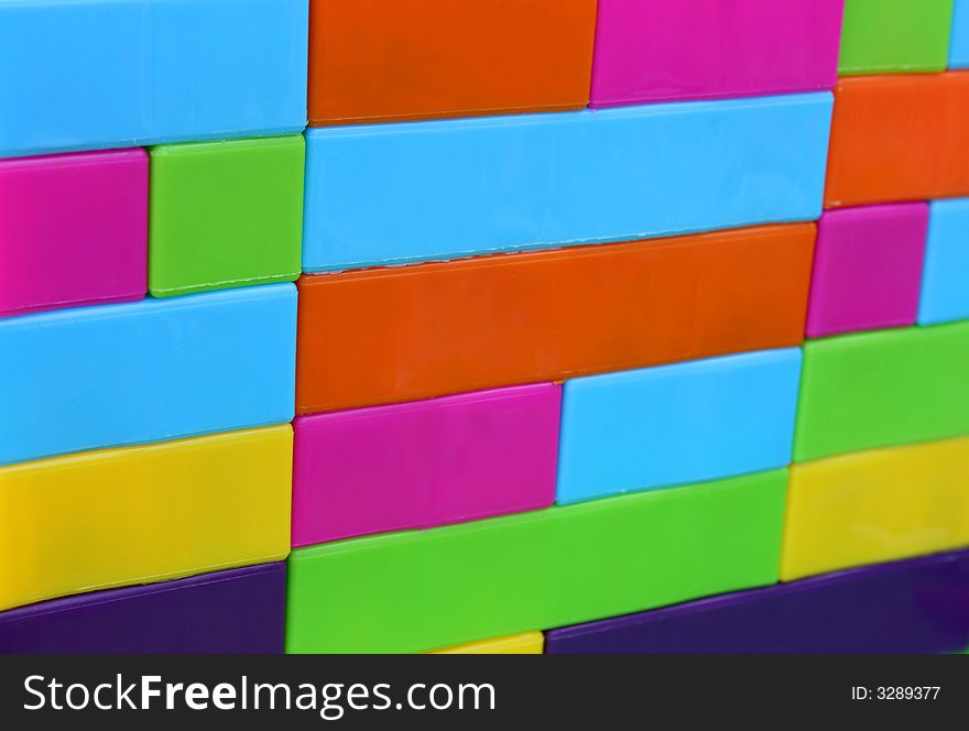 Wall created by colorful building blocks stacked onto one another. Wall created by colorful building blocks stacked onto one another