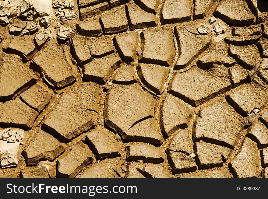 Dried soil cracking under the scorching sun. Dried soil cracking under the scorching sun