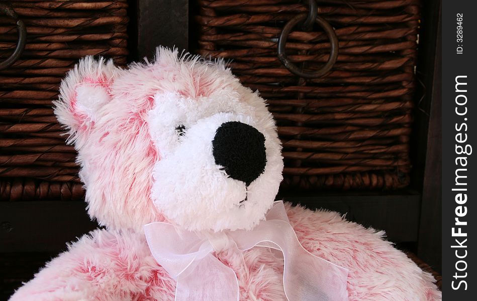 Pink and white teddy bear in a rustic type drawer