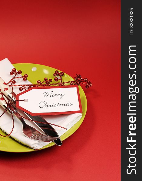 Modern trend lime green and red Merry Christmas table place setting. Vertical with copy space for your text here.