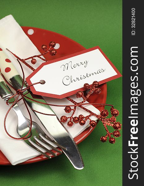 Red and green Merry Christmas dinner table place setting - vertical closeup