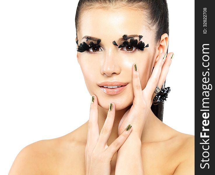 Closeup portrait of the beautiful woman with long black false eyelashes makeup and golden nails. isolated on white background. Closeup portrait of the beautiful woman with long black false eyelashes makeup and golden nails. isolated on white background