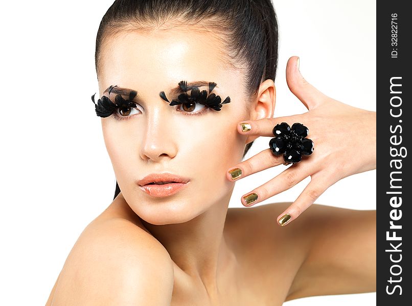 Closeup portrait of the beautiful woman with long black false eyelashes makeup and golden nails. isolated on white background. Closeup portrait of the beautiful woman with long black false eyelashes makeup and golden nails. isolated on white background