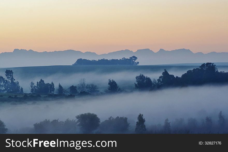 Landscape with morning fog over trees at sunrise. Landscape with morning fog over trees at sunrise