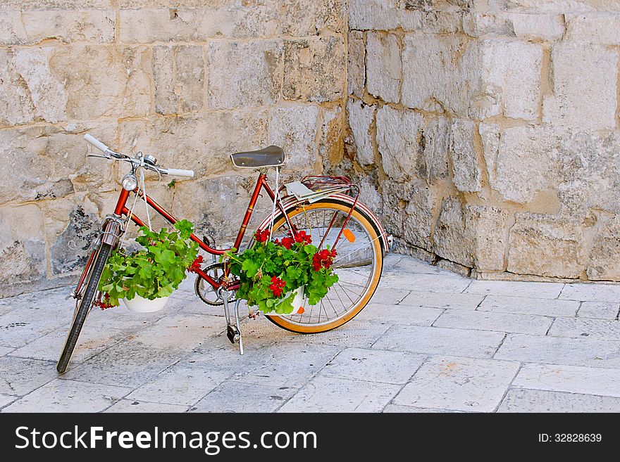Red bike with geranium flowers. Red bike with geranium flowers.