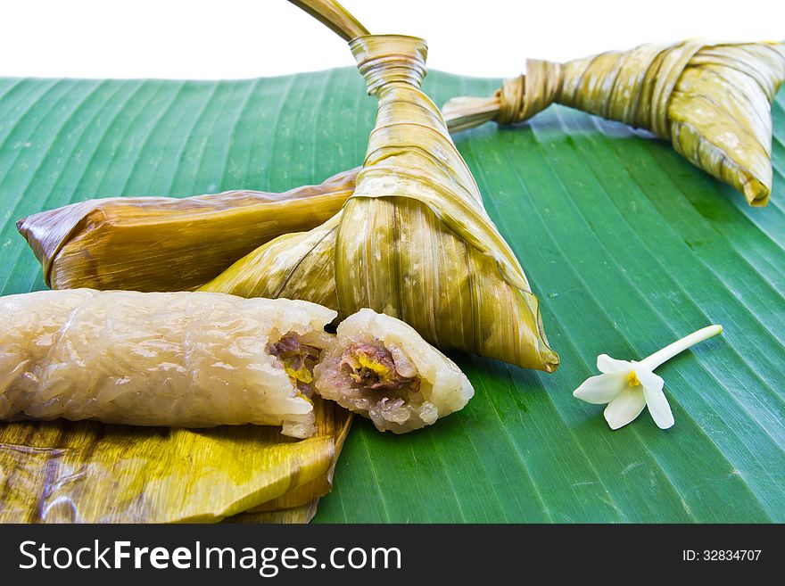 Sticky rice with banana fruit , wrapped in banana leaves traditional Thai. Sticky rice with banana fruit , wrapped in banana leaves traditional Thai.