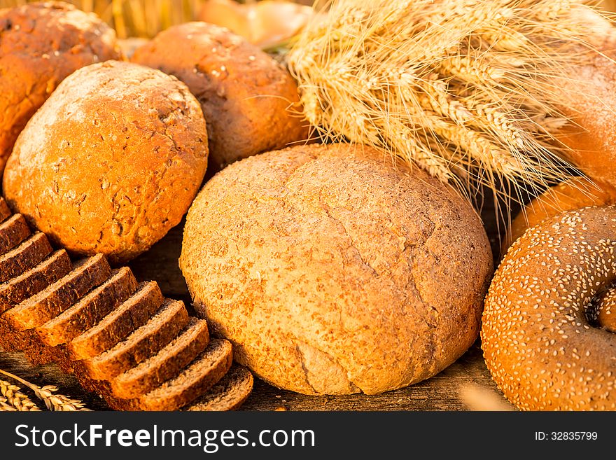 Bread And Wheat On The Wooden Table