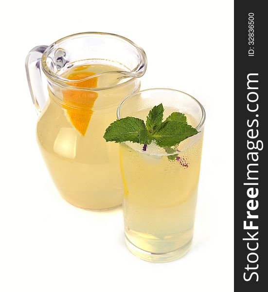 Lemon juice in a jug and a glass with mint