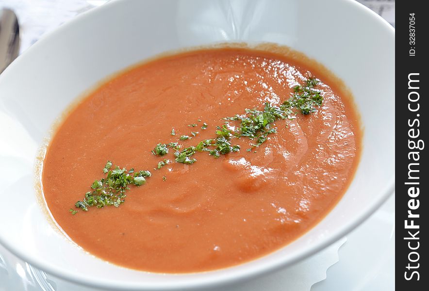 Spanish cold tomato based soup gazpacho served in a white bow