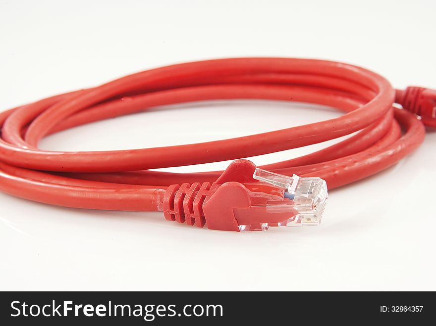 Red ethernet cable isolated against white