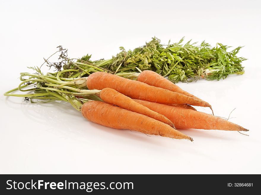 Organic carrots grown on a farm against white