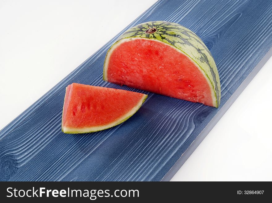 Fresh Melon quarters against coloured wood