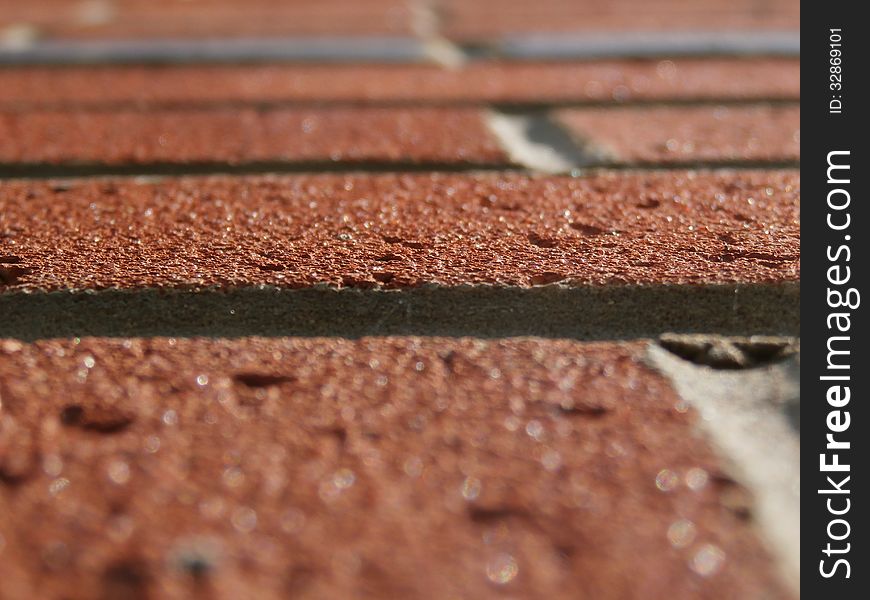 Close up tilted view of sunlit red brickwork. Close up tilted view of sunlit red brickwork.